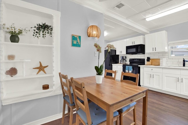 3230 4th Ave S, Saint Petersburg, FL 33712 - dining room with dark wood-style flooring and beamed ceiling