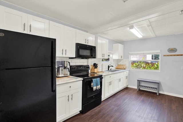 3230 4th Ave S, Saint Petersburg, FL 33712 - kitchen with black appliances, a sink, tasteful backsplash, light countertops, and white cabinets