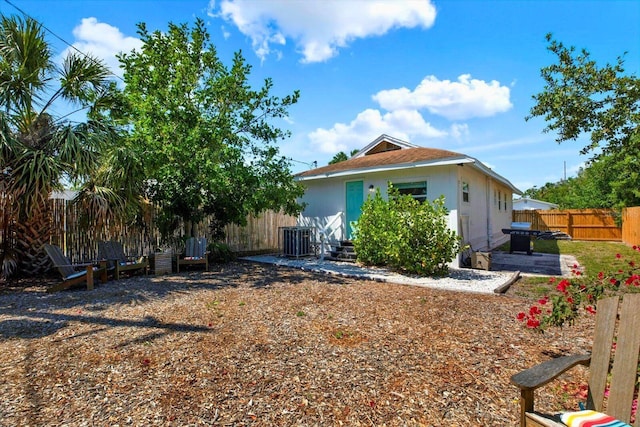 3230 4th Ave S, Saint Petersburg, FL 33712 - rear view of house featuring central AC unit, a fenced backyard, and a patio