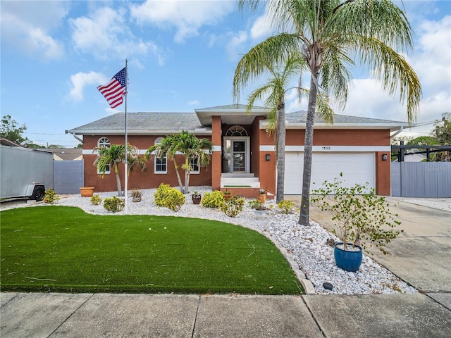 1102 Goshen Rd, Tarpon Springs, FL 34689 - ranch-style home featuring stucco siding, driveway, and an attached garage
