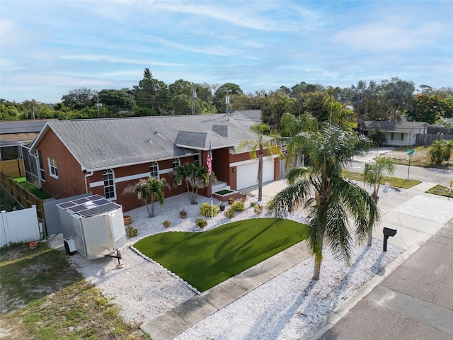 1102 Goshen Rd, Tarpon Springs, FL 34689 - view of front of house featuring driveway, roof with shingles, and an outbuilding