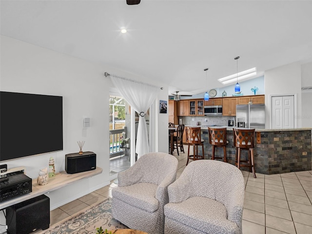 1102 Goshen Rd, Tarpon Springs, FL 34689 - living room with light tile patterned floors, lofted ceiling, and a skylight