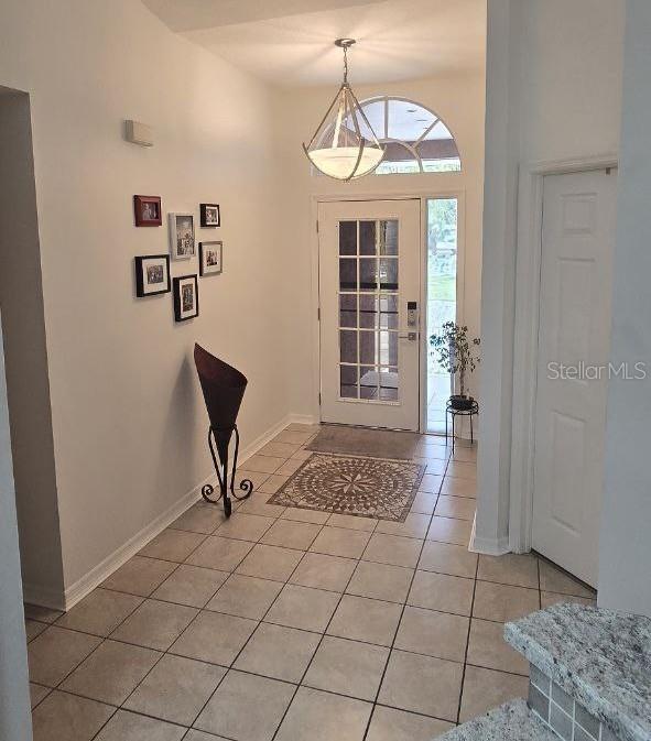 1102 Goshen Rd, Tarpon Springs, FL 34689 - entryway featuring light tile patterned floors and baseboards