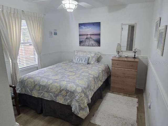 1102 Goshen Rd, Tarpon Springs, FL 34689 - bedroom featuring wood finished floors and a ceiling fan