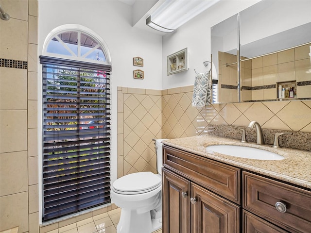 1102 Goshen Rd, Tarpon Springs, FL 34689 - bathroom with vanity, tile walls, toilet, tile patterned floors, and a shower