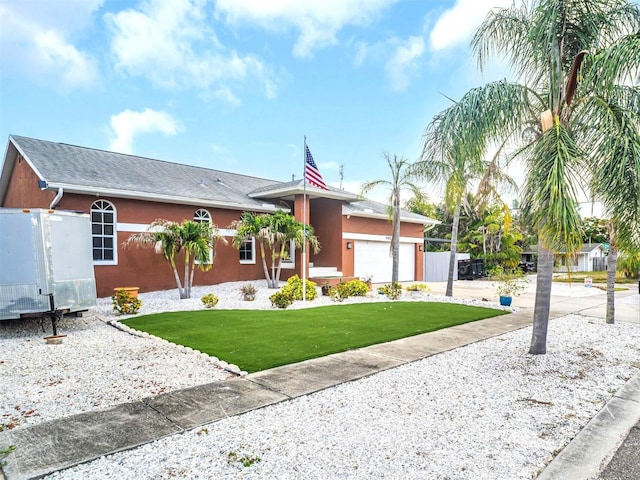 1102 Goshen Rd, Tarpon Springs, FL 34689 - view of front facade with an attached garage, a front lawn, driveway, and stucco siding