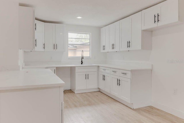 1255 Pine St, Altamonte Springs, FL 32701 - kitchen featuring a sink, light wood-style floors, white cabinetry, and recessed lighting