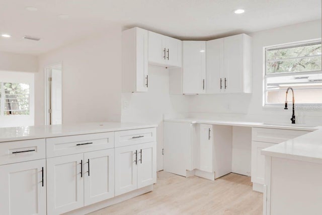 1255 Pine St, Altamonte Springs, FL 32701 - kitchen featuring a sink, light wood finished floors, recessed lighting, white cabinets, and light countertops