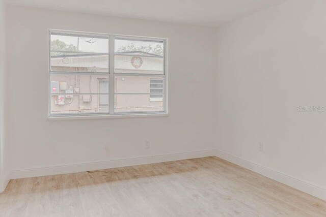 1255 Pine St, Altamonte Springs, FL 32701 - empty room with wood finished floors and baseboards