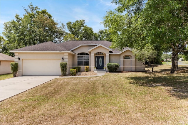 9700 SW 196th Cir, Dunnellon, FL 34432 - single story home with stucco siding, a garage, driveway, a front lawn, and a shingled roof