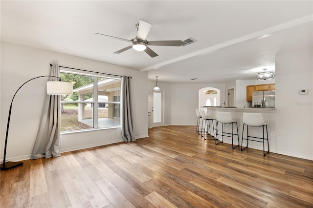 9700 SW 196th Cir, Dunnellon, FL 34432 - living room featuring a ceiling fan, light wood-type flooring, and baseboards