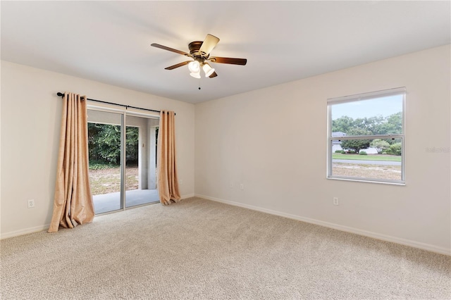 9700 SW 196th Cir, Dunnellon, FL 34432 - empty room featuring light colored carpet, healthy amount of natural light, a ceiling fan, and baseboards