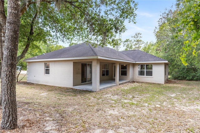 9700 SW 196th Cir, Dunnellon, FL 34432 - rear view of house with a patio, stucco siding, and a shingled roof
