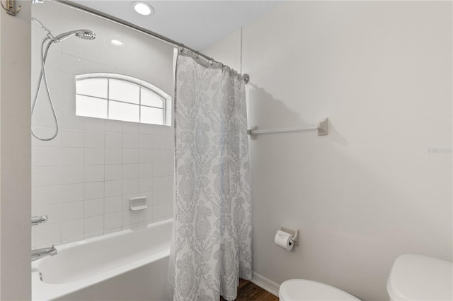 9700 SW 196th Cir, Dunnellon, FL 34432 - full bath with toilet, shower / bathtub combination with curtain, wood finished floors, recessed lighting, and baseboards