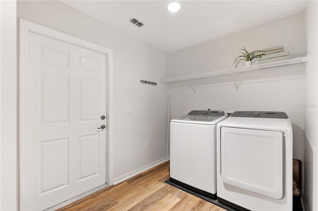9700 SW 196th Cir, Dunnellon, FL 34432 - laundry area with washing machine and clothes dryer, light wood finished floors, baseboards, and recessed lighting