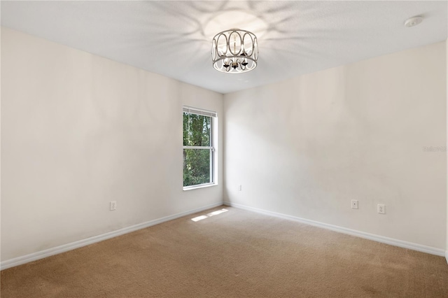 9700 SW 196th Cir, Dunnellon, FL 34432 - carpeted spare room featuring a chandelier, baseboards, and a smoke detector