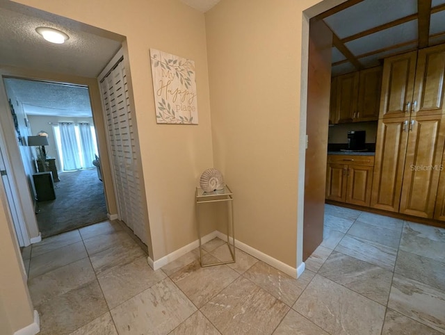 8765 Bardmoor Blvd Unit 108, Seminole, FL 33777 - hall featuring baseboards and a textured ceiling