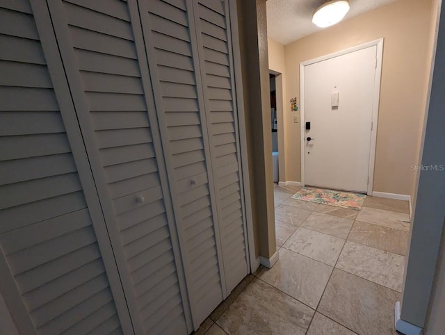 8765 Bardmoor Blvd Unit 108, Seminole, FL 33777 - entrance foyer featuring baseboards and light tile patterned floors
