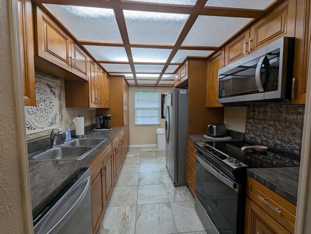 8765 Bardmoor Blvd Unit 108, Seminole, FL 33777 - kitchen featuring stainless steel appliances, a sink, brown cabinets, and dark countertops
