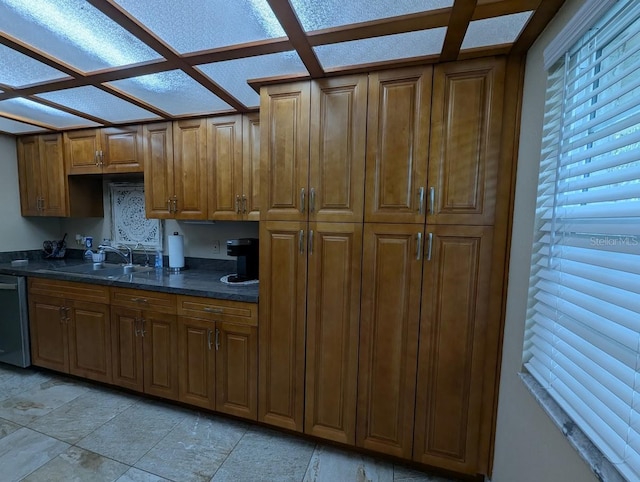8765 Bardmoor Blvd Unit 108, Seminole, FL 33777 - kitchen with dark countertops, a sink, stainless steel dishwasher, and brown cabinets