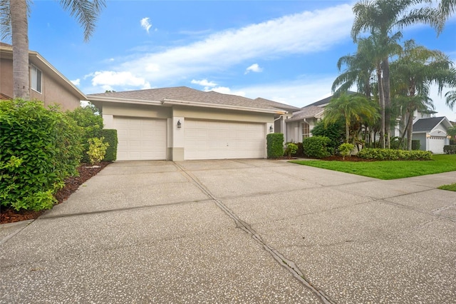 9402 Woodbay Dr, Tampa, FL 33626 - view of front of house with stucco siding, driveway, and an attached garage
