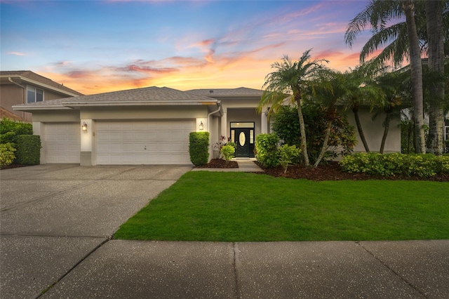 9402 Woodbay Dr, Tampa, FL 33626 - view of front of property featuring stucco siding, a garage, driveway, and a yard