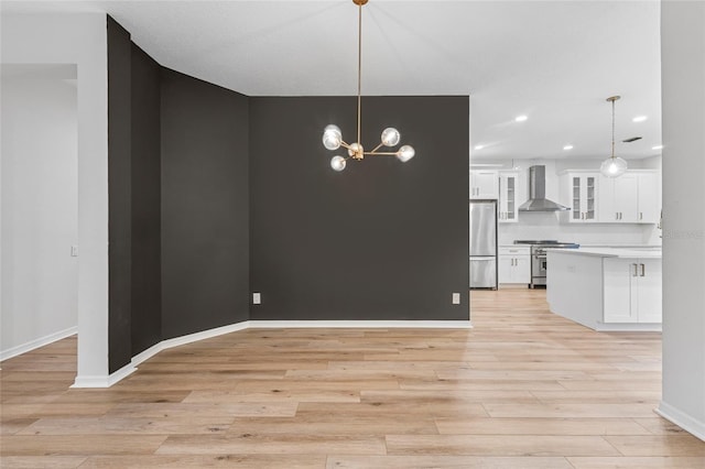 9402 Woodbay Dr, Tampa, FL 33626 - unfurnished dining area featuring light wood finished floors, recessed lighting, baseboards, and a chandelier