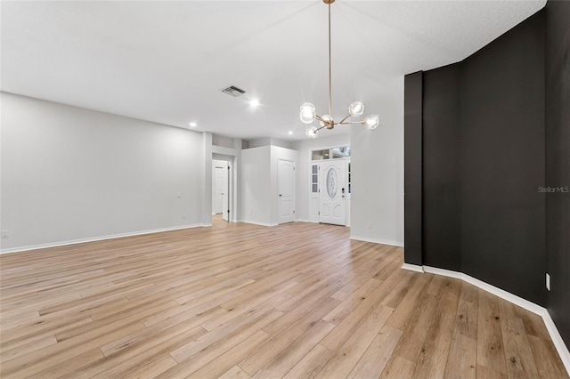 9402 Woodbay Dr, Tampa, FL 33626 - unfurnished living room featuring light wood-style floors, a chandelier, recessed lighting, and baseboards