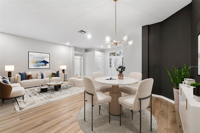 9402 Woodbay Dr, Tampa, FL 33626 - dining room featuring light wood-style flooring, a chandelier, and recessed lighting