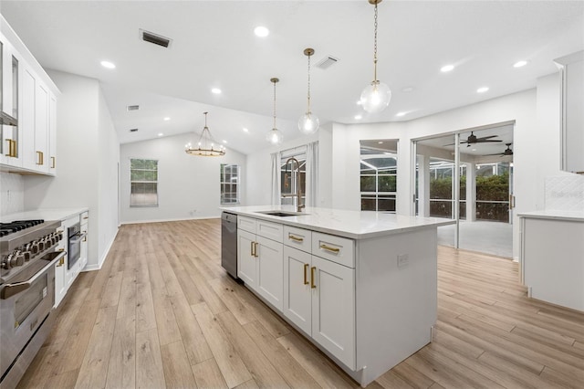 9402 Woodbay Dr, Tampa, FL 33626 - kitchen featuring a sink, stainless steel appliances, light wood-type flooring, white cabinetry, and vaulted ceiling
