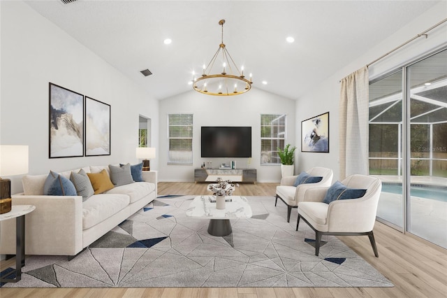 9402 Woodbay Dr, Tampa, FL 33626 - living room featuring a chandelier, wood finished floors, healthy amount of natural light, recessed lighting, and high vaulted ceiling