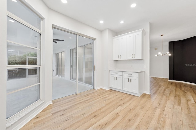 9402 Woodbay Dr, Tampa, FL 33626 - interior space with light wood-style flooring, a chandelier, and recessed lighting