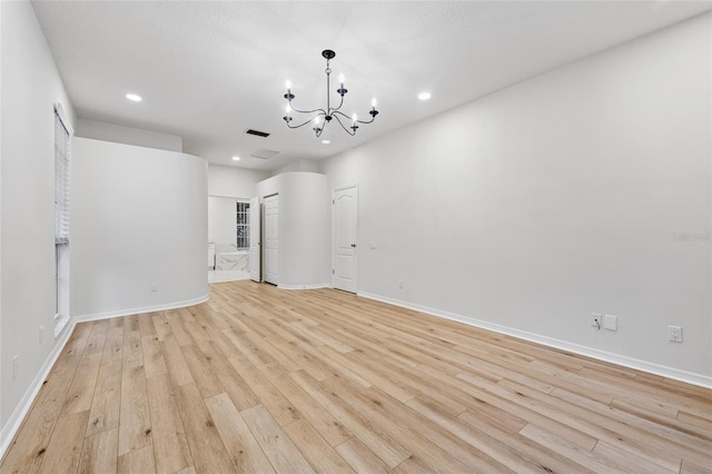 9402 Woodbay Dr, Tampa, FL 33626 - empty room with a chandelier, light wood-style flooring, recessed lighting, and baseboards