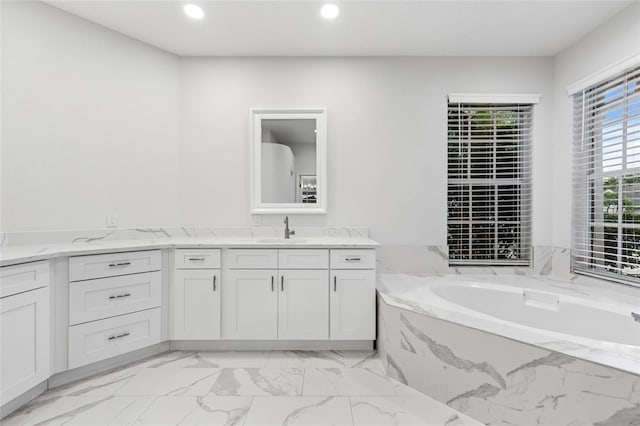 9402 Woodbay Dr, Tampa, FL 33626 - full bathroom with vanity, marble finish floors, recessed lighting, and a garden tub