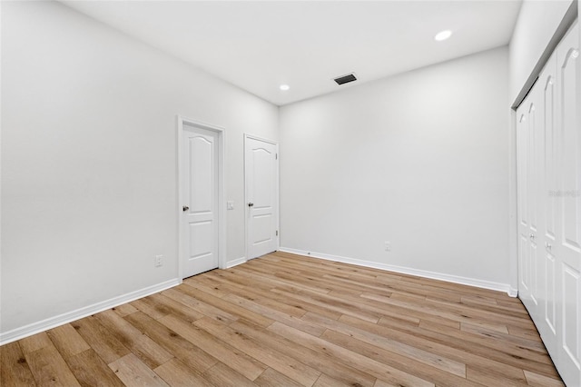 9402 Woodbay Dr, Tampa, FL 33626 - unfurnished bedroom with light wood-style flooring, baseboards, and recessed lighting