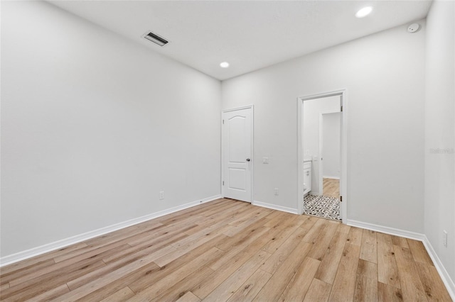 9402 Woodbay Dr, Tampa, FL 33626 - unfurnished bedroom with light wood-type flooring, baseboards, recessed lighting, and connected bathroom