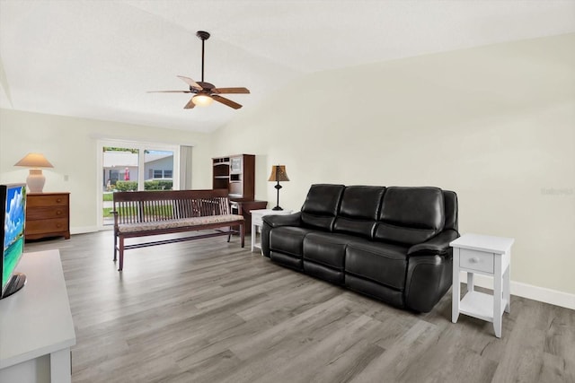 3146 37th Ln S Unit A, Saint Petersburg, FL 33711 - living room with ceiling fan, vaulted ceiling, wood finished floors, and baseboards