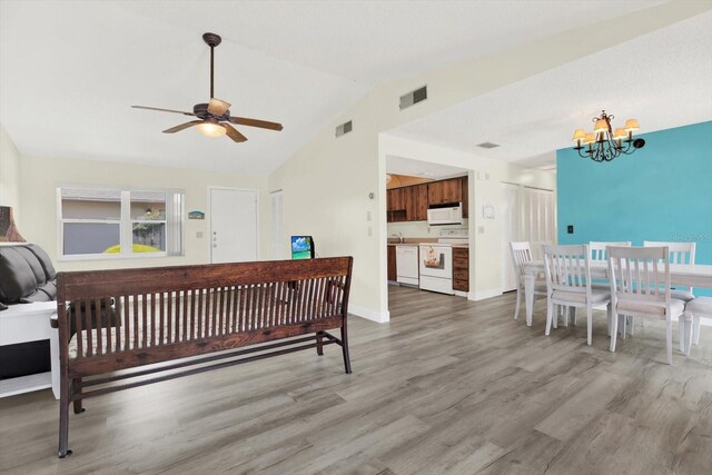 3146 37th Ln S Unit A, Saint Petersburg, FL 33711 - bedroom with a chandelier, light wood-type flooring, vaulted ceiling, and baseboards