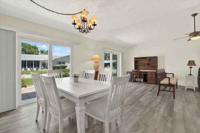 3146 37th Ln S Unit A, Saint Petersburg, FL 33711 - dining area featuring light wood-style flooring, a chandelier, a textured ceiling, and ceiling fan