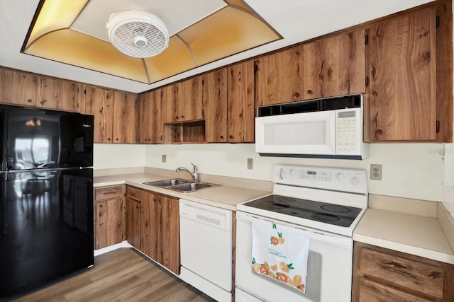 3146 37th Ln S Unit A, Saint Petersburg, FL 33711 - kitchen featuring white appliances, a sink, brown cabinets, and light countertops