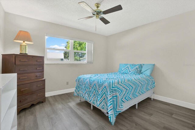 3146 37th Ln S Unit A, Saint Petersburg, FL 33711 - bedroom featuring wood finished floors, baseboards, a textured ceiling, and ceiling fan