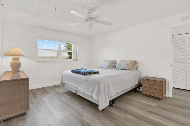 3146 37th Ln S Unit A, Saint Petersburg, FL 33711 - bedroom with wood finished floors, a textured ceiling, baseboards, and a ceiling fan