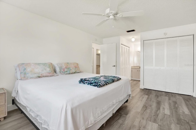 3146 37th Ln S Unit A, Saint Petersburg, FL 33711 - bedroom with wood finished floors, ceiling fan, a textured ceiling, and ensuite bath