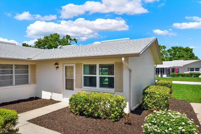 3146 37th Ln S Unit A, Saint Petersburg, FL 33711 - property entrance featuring stucco siding and a shingled roof