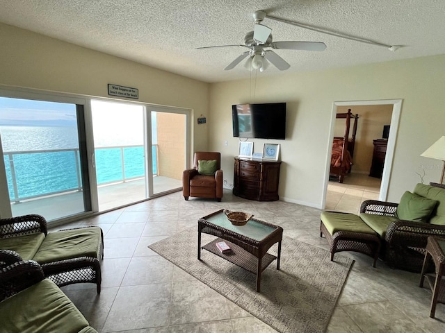 880 Mandalay Ave Unit C1103, Clearwater Beach, FL 33767 - living area with a ceiling fan, a textured ceiling, and light tile patterned floors