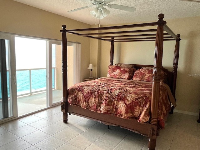 880 Mandalay Ave Unit C1103, Clearwater Beach, FL 33767 - bedroom with access to exterior, a textured ceiling, ceiling fan, and light tile patterned floors