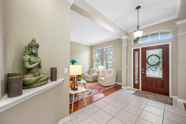 3000 Naughton Way, Tarpon Springs, FL 34688 - foyer entrance featuring crown molding, baseboards, decorative columns, and light tile patterned floors