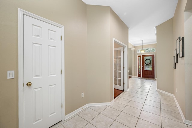 3000 Naughton Way, Tarpon Springs, FL 34688 - corridor featuring baseboards and light tile patterned flooring
