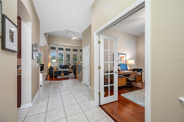 3000 Naughton Way, Tarpon Springs, FL 34688 - corridor with an office area, french doors, light tile patterned flooring, lofted ceiling, and arched walkways