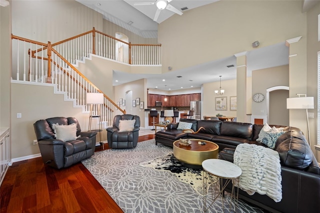 3000 Naughton Way, Tarpon Springs, FL 34688 - living room featuring dark wood finished floors, a towering ceiling, ceiling fan, stairway, and baseboards